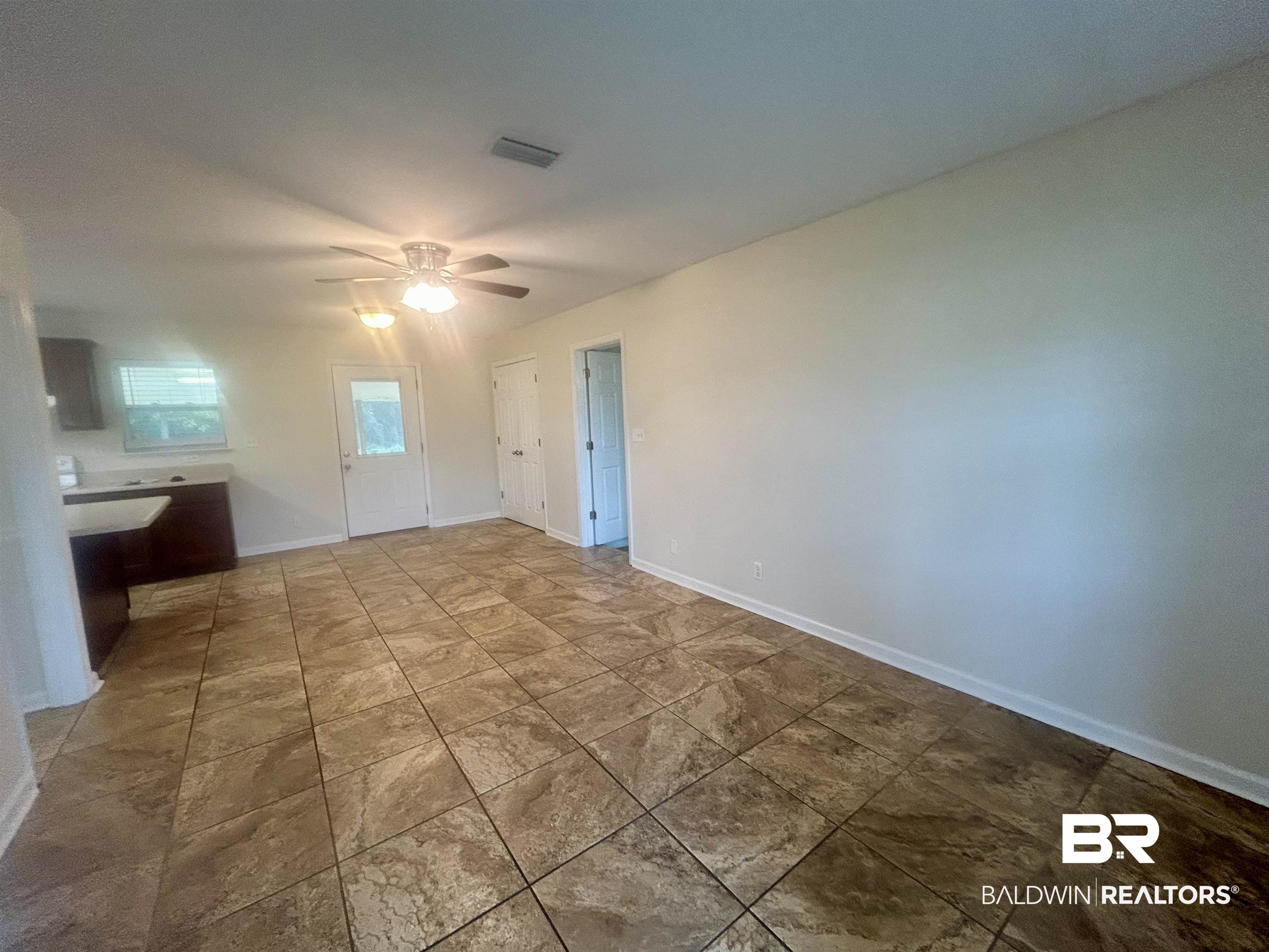 187 Van Hoosen Road Flomaton, AL 36441 - Photo 7 of 29 Unfurnished living room with baseboards and ceiling fan