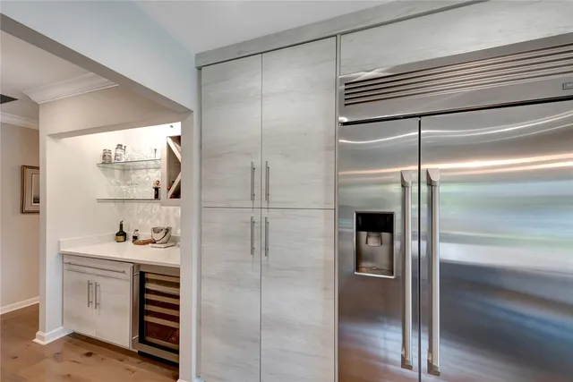 a kitchen with a refrigerator and a sink