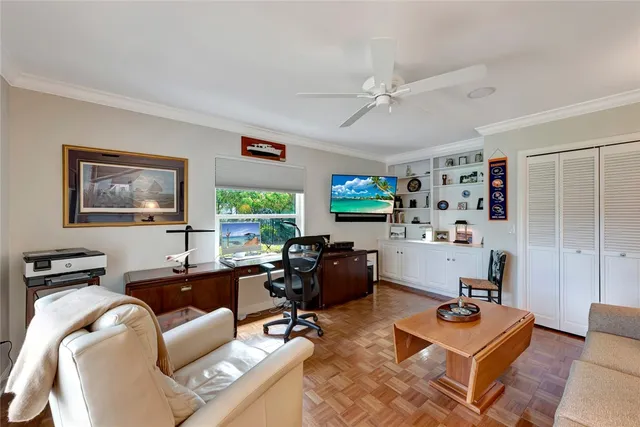 a living room with furniture a flat screen tv and a window