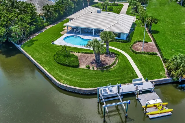 an aerial view of a house with swimming pool garden and patio
