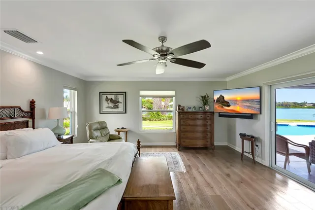 a large bedroom with a bed a table and chair