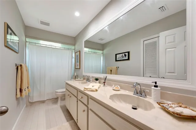 a view of a swimming pool with lawn chairs and a big yard