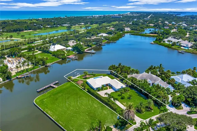 an aerial view of a houses with a lake view and a mountain view