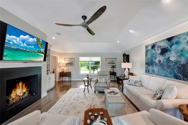 a living room with furniture a fireplace and a flat screen tv