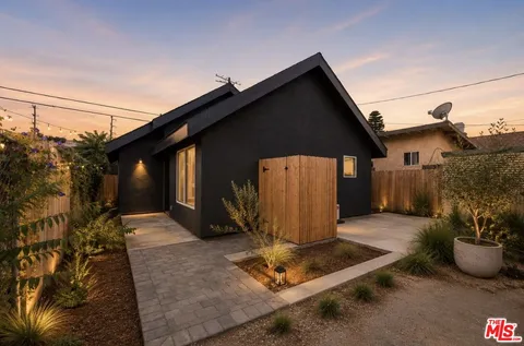 a backyard of a house with yard and outdoor seating