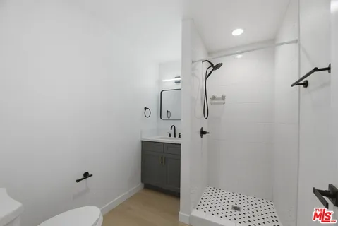a bathroom with a shower toilet and sink
