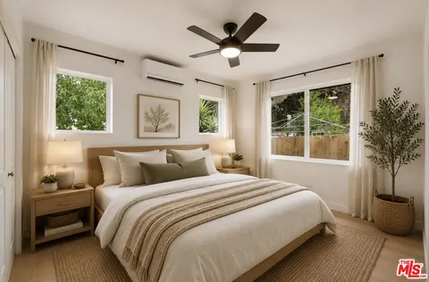a bedroom with a large bed and a window