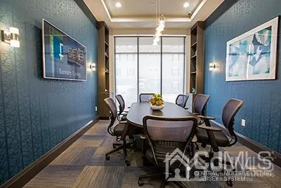 a view of a dining room with furniture a chandelier and wooden floor