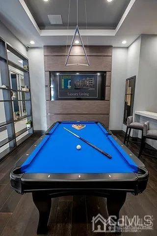 a room with pool table and windows