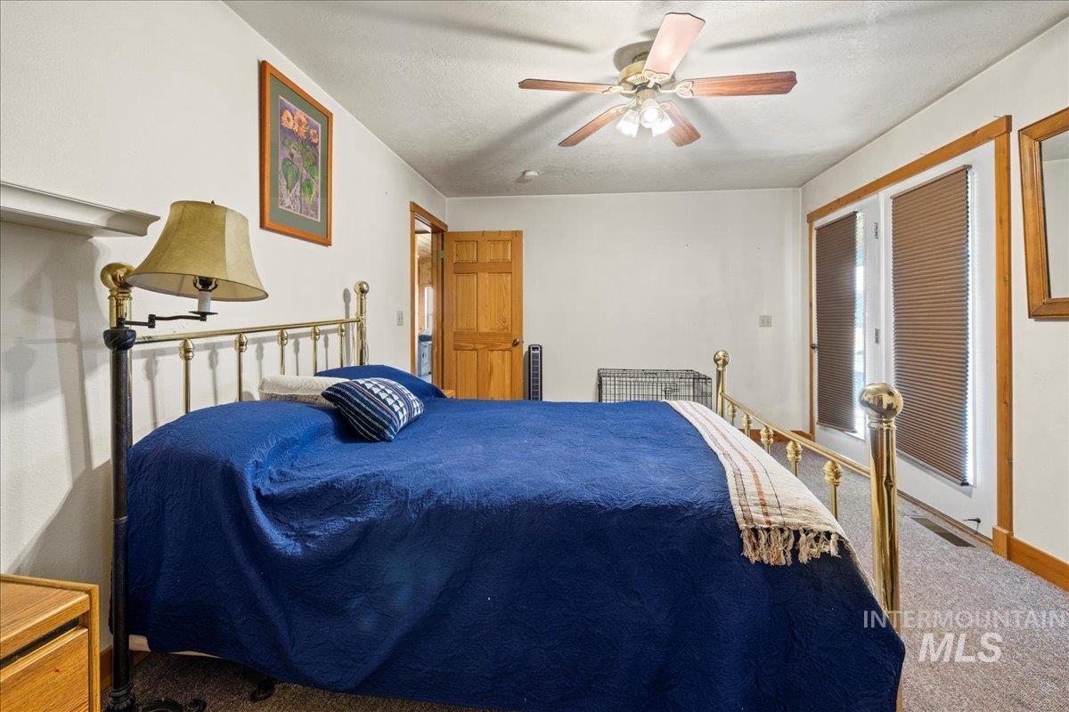 2128 Jackson Creek Road Council, ID 83612 - Photo 27 of 50 Carpeted bedroom with ceiling fan and a textured ceiling