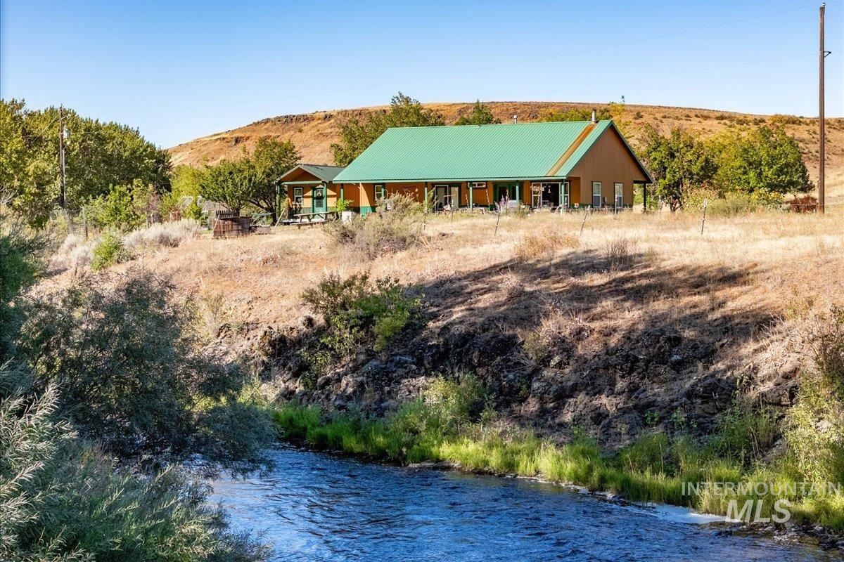 2128 Jackson Creek Road Council, ID 83612 - Photo 3 of 50 Exterior space featuring a metal roof and a water view