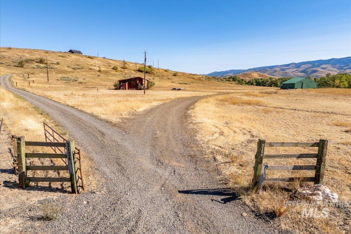 2128 Jackson Creek Road Council, ID 83612 - Photo 38 of 50 View of street featuring a view of countryside, a mountain view, and a gated entry