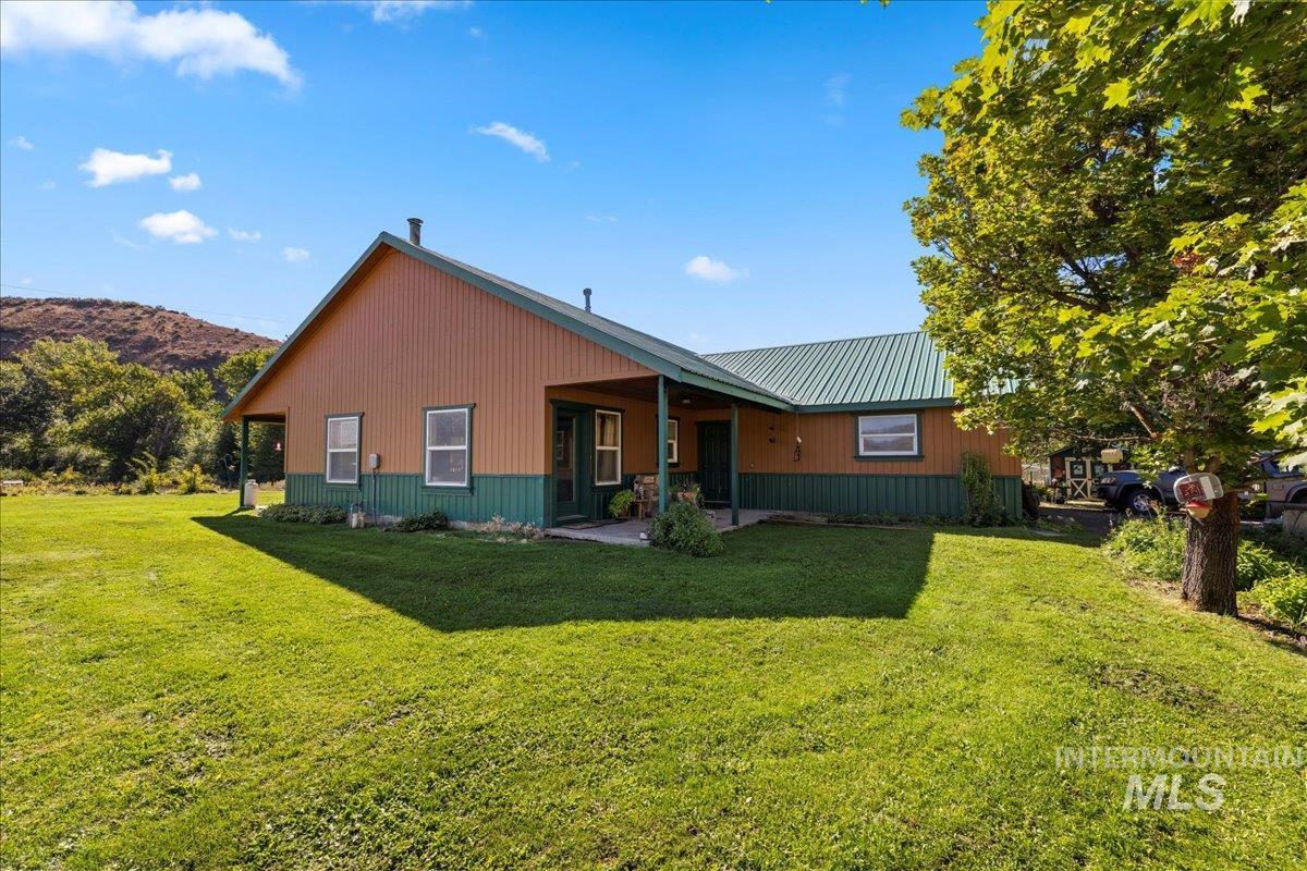 2128 Jackson Creek Road Council, ID 83612 - Photo 6 of 50 Back of property with a lawn, a patio, and a metal roof