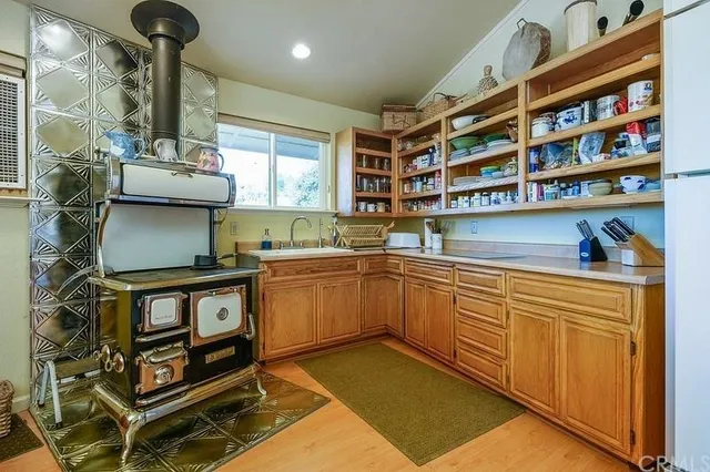 a kitchen with stainless steel appliances granite countertop a sink and cabinets