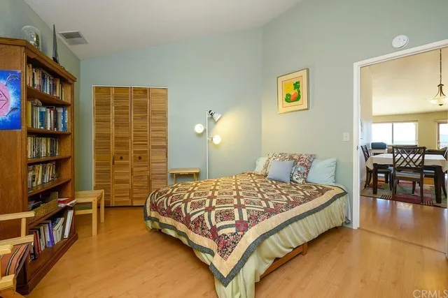 a bedroom with a bed furniture and a book shelf
