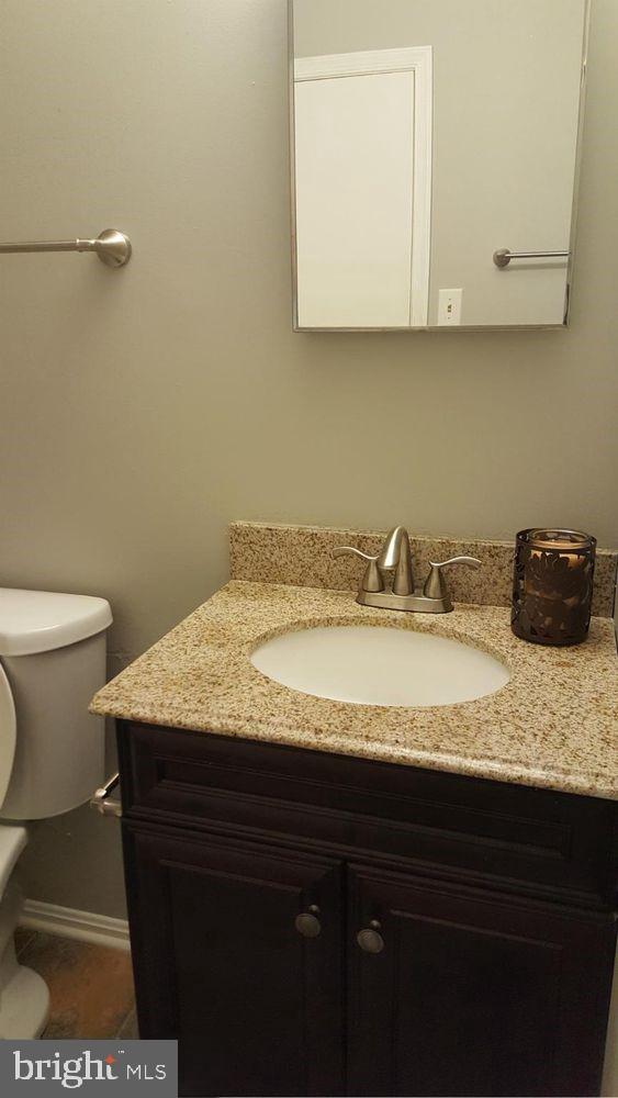 57 Riverside Run Drive Indian Head, MD 20640 - Photo 13 of 24 a bathroom with a granite countertop sink a toilet and mirror