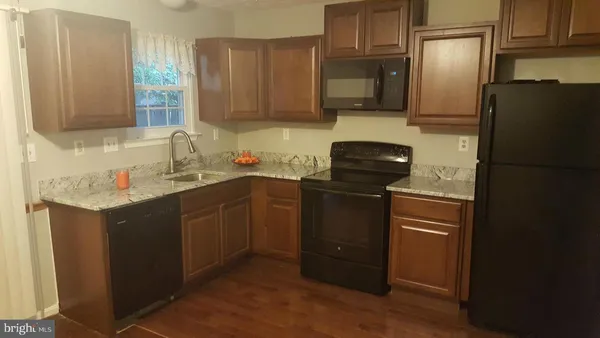 a kitchen with a sink stove and refrigerator
