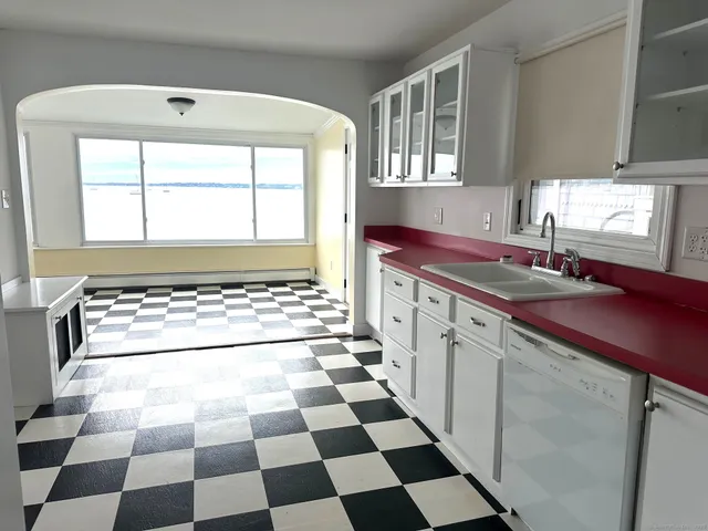 a kitchen with a checkered floor and a stove