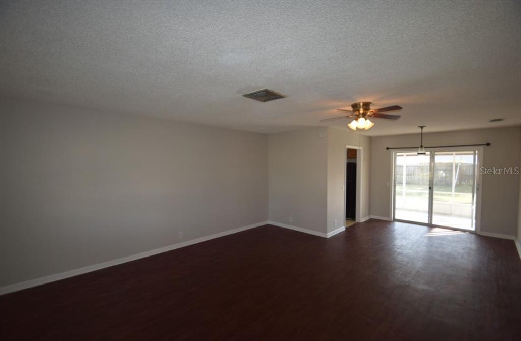 145 Audubon Road Winter Haven, FL 33884 - Photo 14 of 24 a view of an empty room with wooden floor and a window