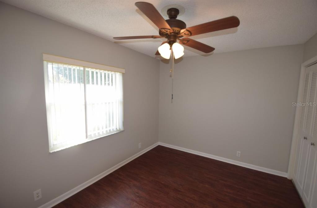 145 Audubon Road Winter Haven, FL 33884 - Photo 17 of 24 a view of an empty room with wooden floor and a window