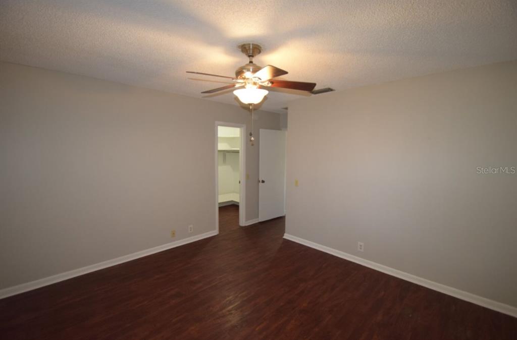 145 Audubon Road Winter Haven, FL 33884 - Photo 9 of 24 a view of an empty room with wooden floor