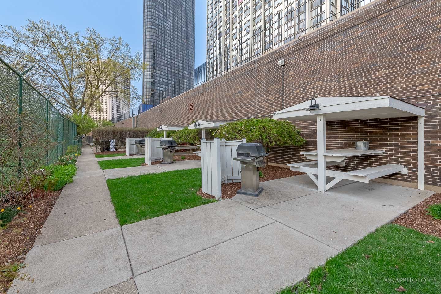 5455 North Sheridan Road, Unit 2008 Chicago, IL 60640 - Photo 20 of 35 a view of a patio with table and chairs under an umbrella