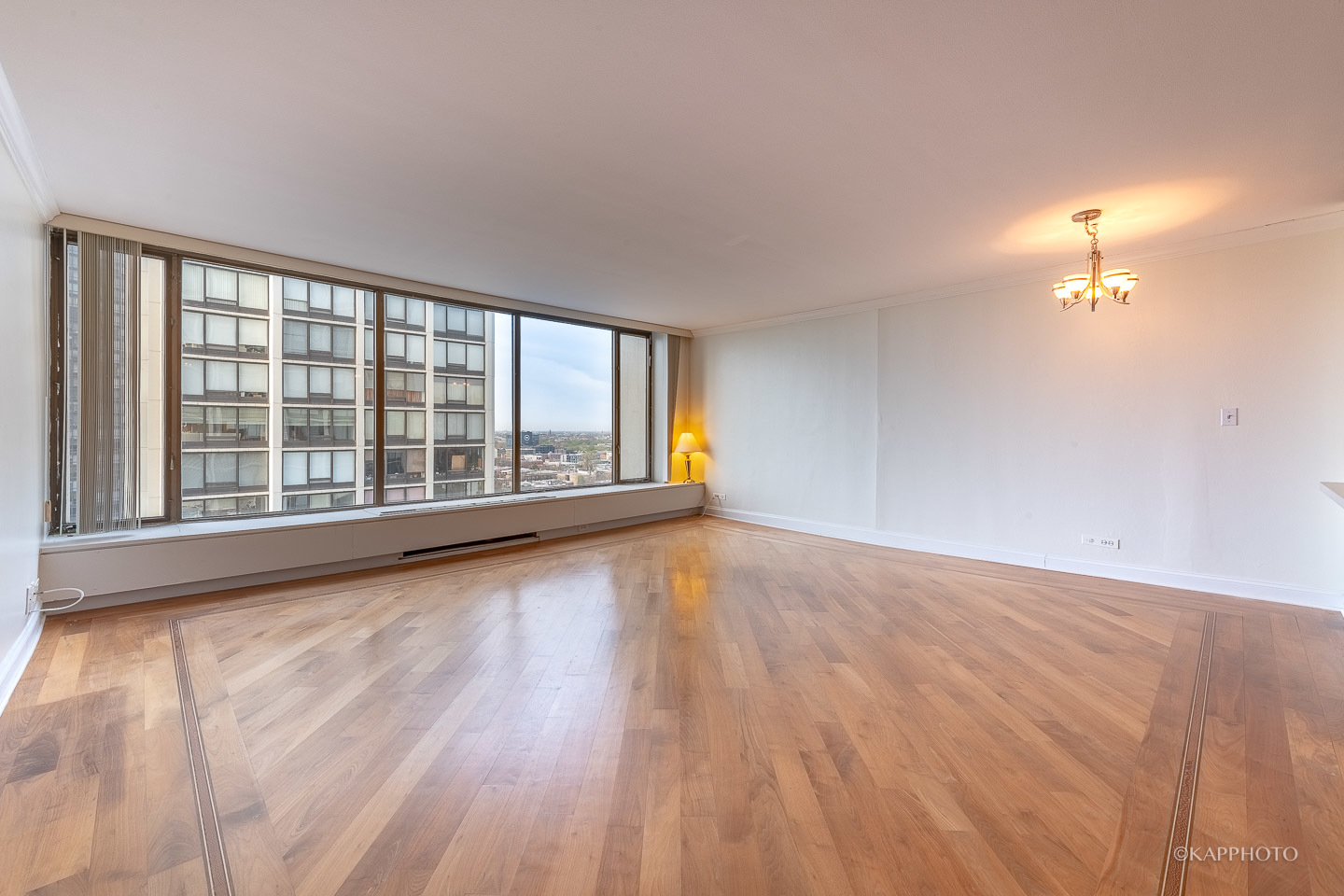 5455 North Sheridan Road, Unit 2008 Chicago, IL 60640 - Photo 2 of 35 wooden floor in an empty room with a window