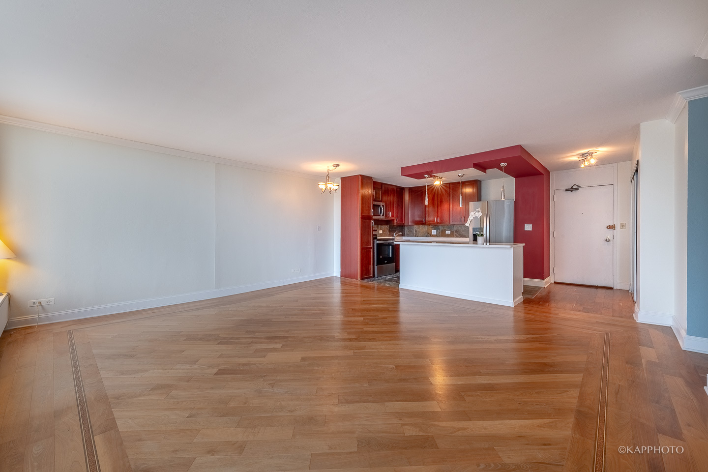 5455 North Sheridan Road, Unit 2008 Chicago, IL 60640 - Photo 4 of 35 a view of a kitchen with a fridge and wooden floor