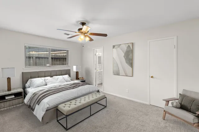 a bedroom with a bed couch and window