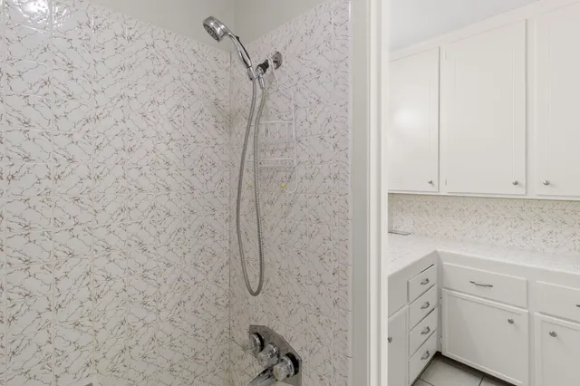 a bathroom with a shower and vanity