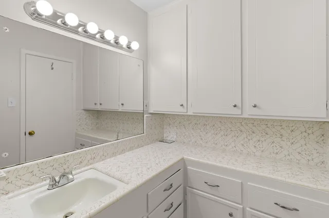 a bathroom with a sink and cabinets