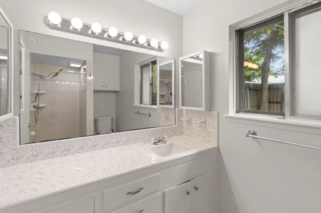 a bathroom with a sink double vanity and a mirror