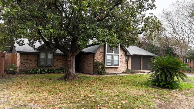a front view of house with yard and trees around