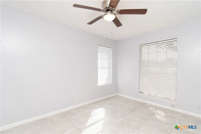 a view of a room with window and a ceiling fan