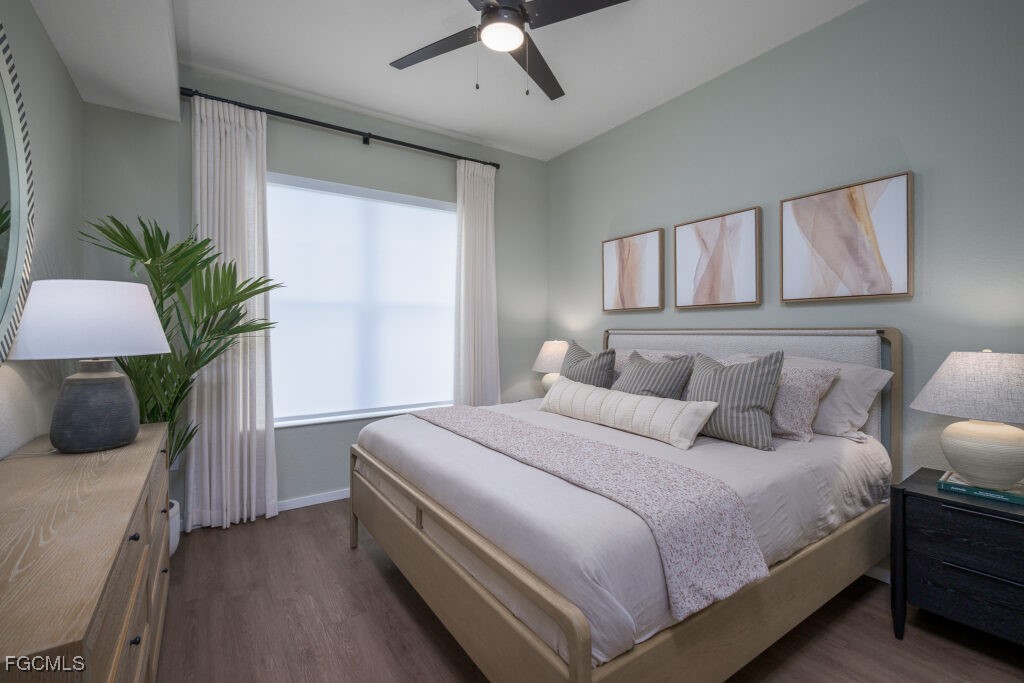 8552 Collier Boulevard, Unit RAVELLO Naples, FL 34114 - Photo 12 of 20 a bedroom with a large bed and a chandelier