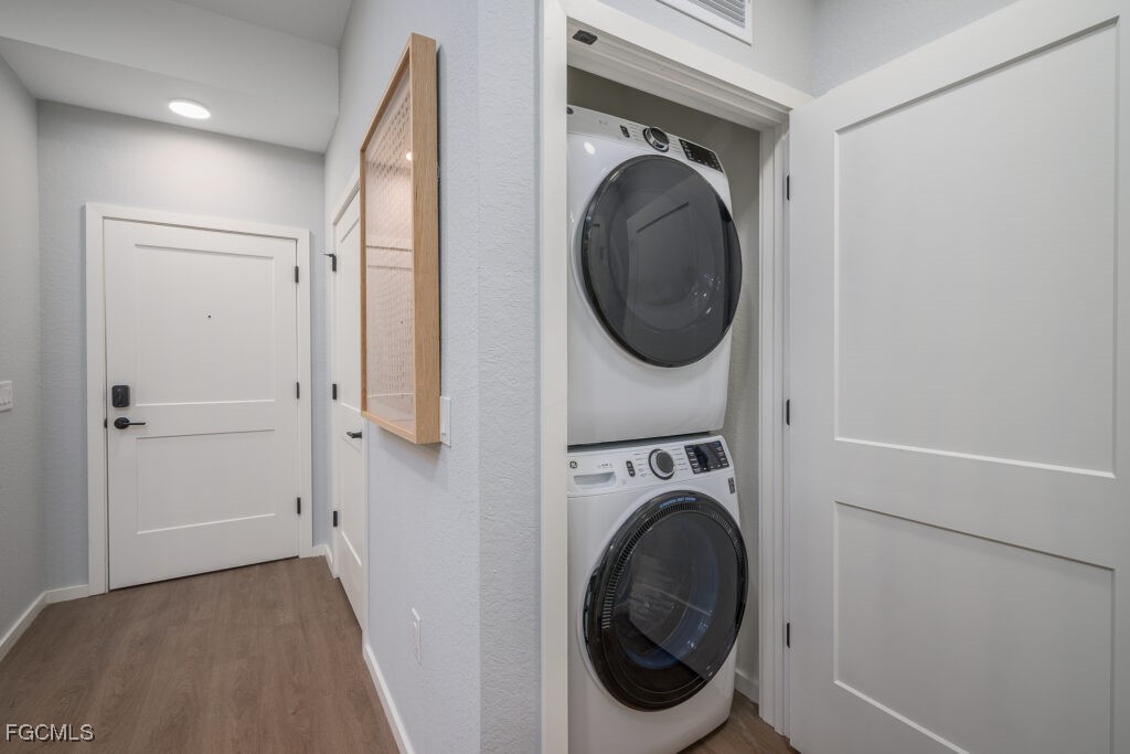 8552 Collier Boulevard, Unit RAVELLO Naples, FL 34114 - Photo 17 of 20 a view of a hallway with washer and dryer