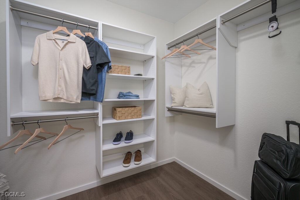 8552 Collier Boulevard, Unit RAVELLO Naples, FL 34114 - Photo 19 of 20 a view of walk in closet with clothes and shoes