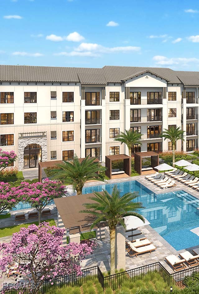 8552 Collier Boulevard, Unit RAVELLO Naples, FL 34114 - Photo 20 of 20 a front view of a building with swimming pool and outdoor seating