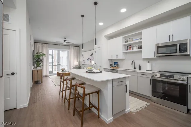 a kitchen with a table chairs stove and microwave