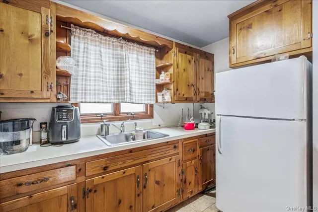 a kitchen with refrigerator cabinets and a sink