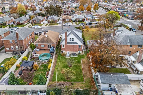 an aerial view of residential houses with outdoor space and swimming pool