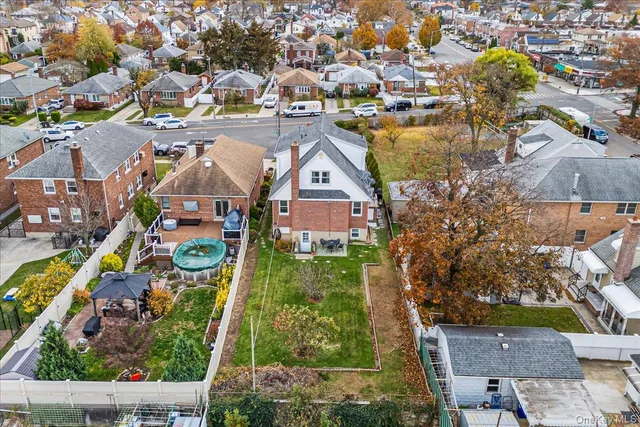 an aerial view of residential houses with outdoor space and swimming pool