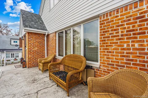 a blue house with lawn chairs