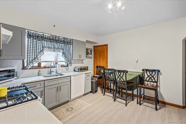 a kitchen that has a sink and a stove in it