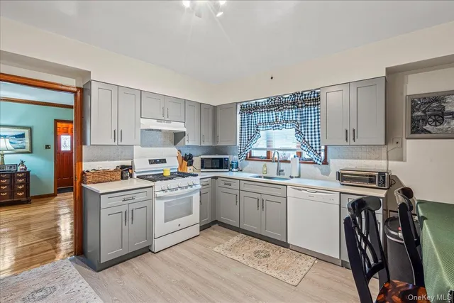 a kitchen with a sink stove and cabinets