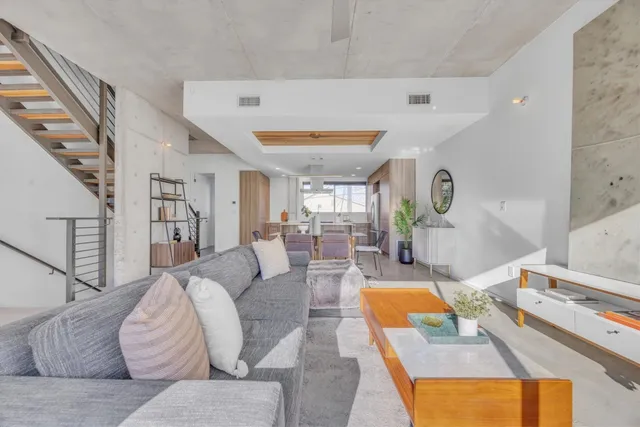 a living room with furniture and a potted plant