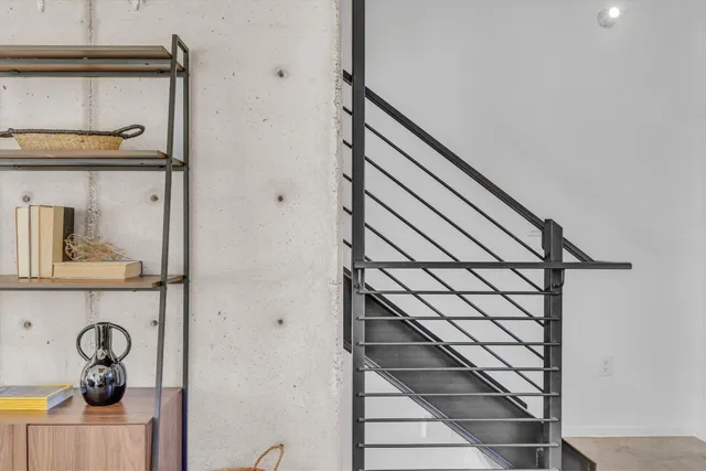 a bedroom with a large window and a balcony