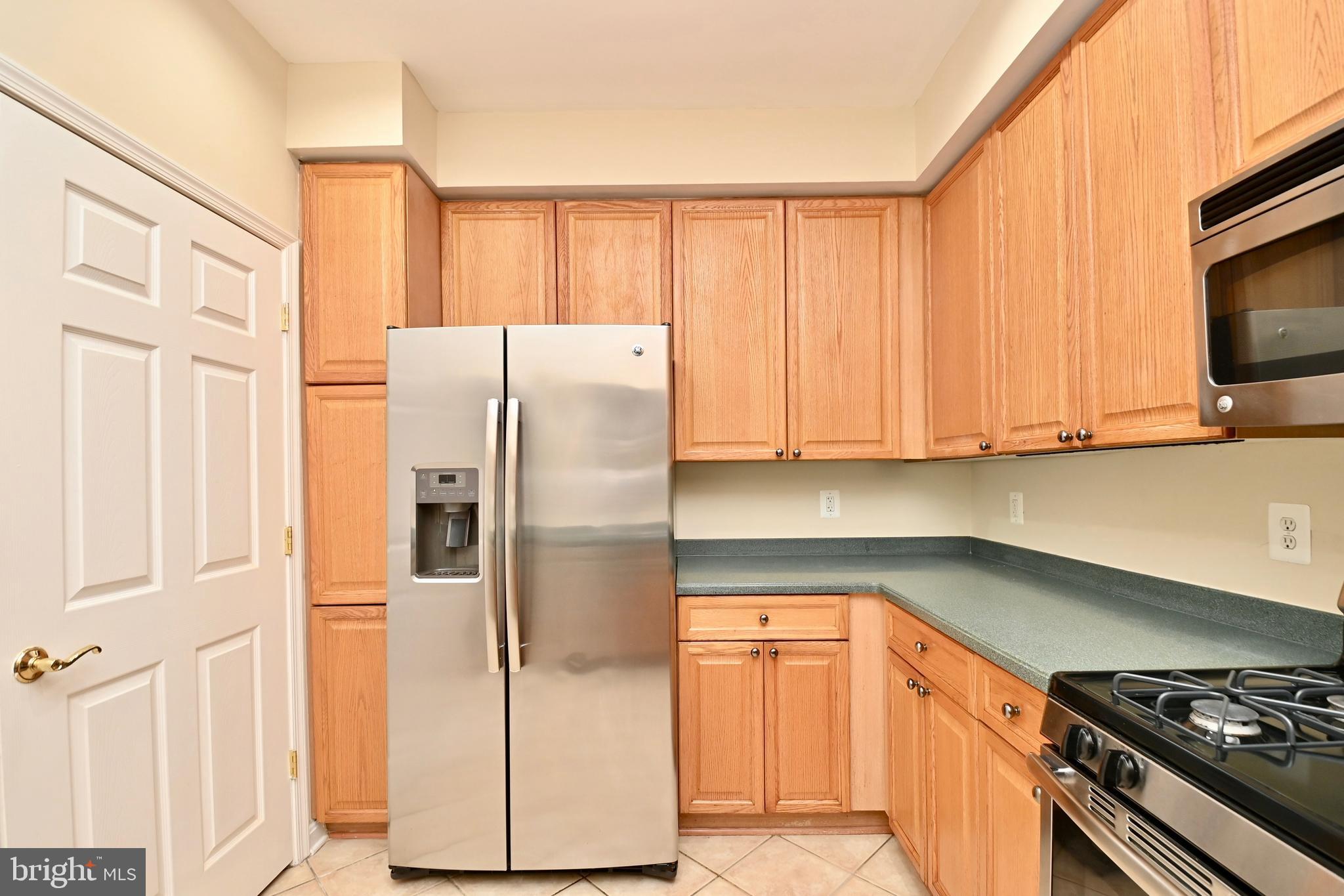 11775 Stratford House Place, Unit 104 Reston, VA 20190 - Photo 16 of 34 a kitchen with stainless steel appliances granite countertop a refrigerator and a stove