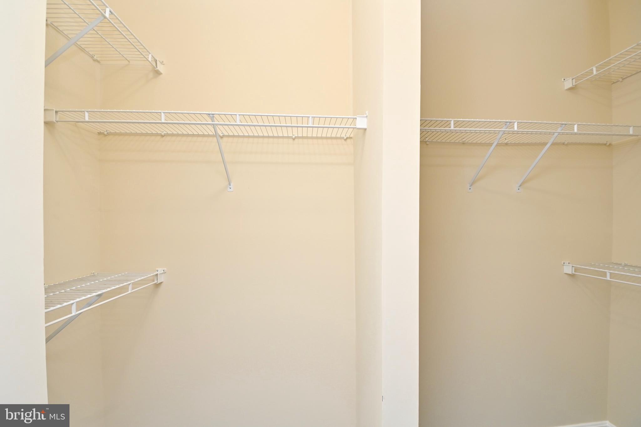 11775 Stratford House Place, Unit 104 Reston, VA 20190 - Photo 29 of 34 a view of walk in closet with empty racks