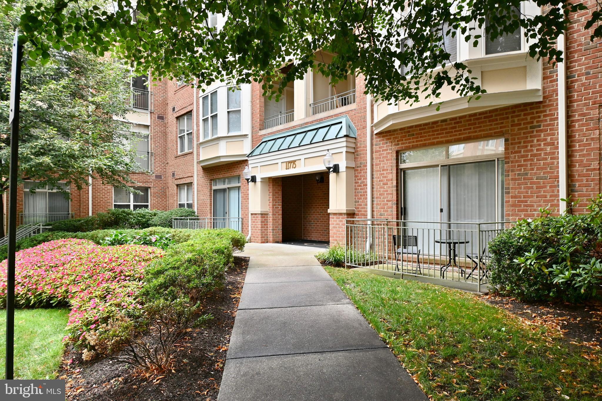11775 Stratford House Place, Unit 104 Reston, VA 20190 - Photo 3 of 34 front view of a house with a yard